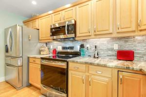 a kitchen with wooden cabinets and stainless steel appliances at Almost There in Bradenton
