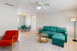a living room with a couch and chairs and a table at Gertie's Lime House in Holmes Beach