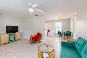 a living room with a couch and a tv at Gertie's Lime House in Holmes Beach