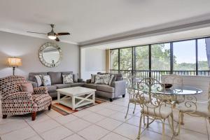 a living room with a couch and a table at Midnight Cove II 823 in Siesta Key