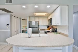 a kitchen with a white counter top and a refrigerator at Midnight Cove II 823 in Siesta Key +25 photos