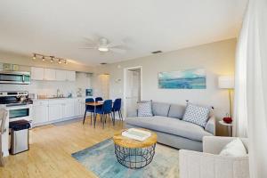 a living room with a couch and a table at Bay View Inn 202 in Bradenton Beach