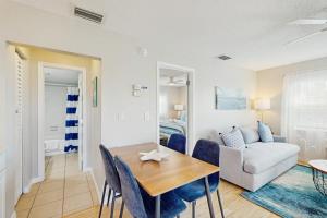 a living room with a table and a couch at Bay View Inn 202 in Bradenton Beach