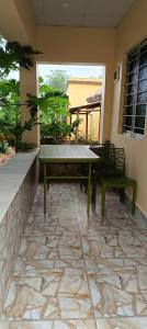 a patio with a table and chairs on a patio at Bagan Bilas Homestay in Jhilimili
