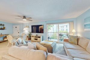 a living room with two couches and a television at Gulf Place 19 in Holmes Beach