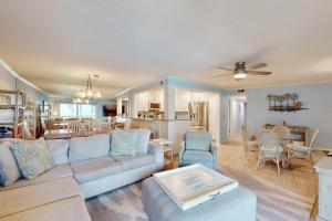a living room with a couch and a dining room at Gulf Place 19 in Holmes Beach