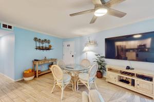 a dining room with a glass table and chairs at Gulf Place 19 in Holmes Beach