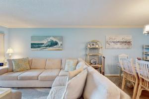 a living room with a couch and a table at Gulf Place 19 in Holmes Beach