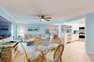a living room with a couch and a table at Gulf Place 19 in Holmes Beach +23 photos