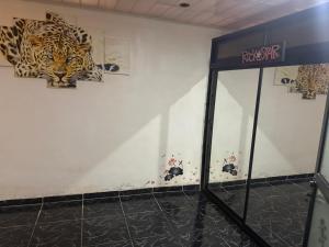 a room with paintings of tigers on the wall at La comodidad a su alcance in La Cuesta