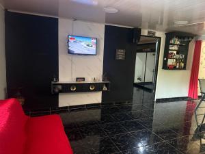 a living room with a tv on a wall at La comodidad a su alcance in La Cuesta