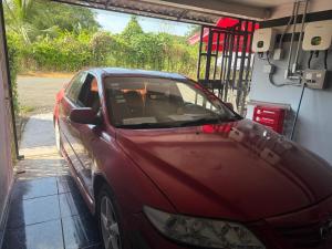 a red car is parked in a garage at La comodidad a su alcance in La Cuesta