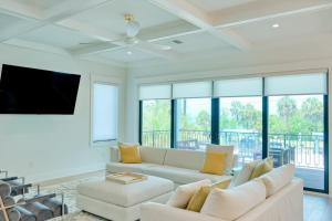 a living room with a couch and a tv at Gulf View Estate in Anna Maria
