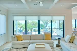 a living room with a white couch and yellow pillows at Gulf View Estate in Anna Maria