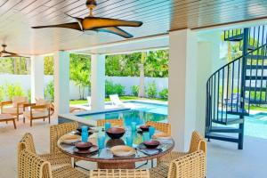 a dining room with a table and chairs and a pool at Gulf View Estate in Anna Maria
