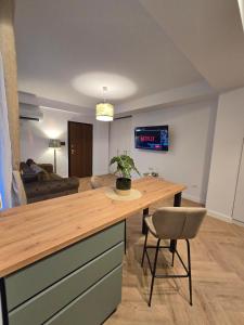 a kitchen and living room with a wooden counter top at Cozy Central Home & Free Private Parking in Craiova