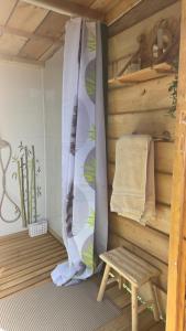 a room with a bed and a bench and a wall at Un aparté bohême "La Roubane" in Puyravault
