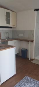 a kitchen with a table and a counter top at L'évidence in Alcantarilha