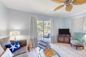 a living room with a couch and a television at Fountain Head 5 in Holmes Beach