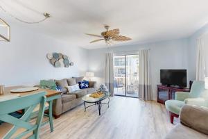 a living room with a couch and a tv at Fountain Head 5 in Holmes Beach