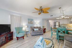 a living room with a couch a table and a kitchen at Fountain Head 5 in Holmes Beach