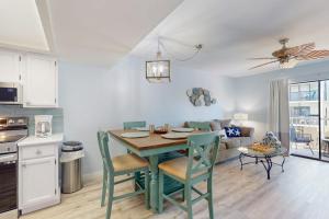 a kitchen and living room with a table and chairs at Fountain Head 5 in Holmes Beach