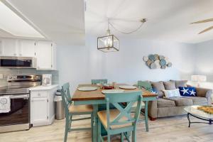 a kitchen and living room with a table and chairs at Fountain Head 5 in Holmes Beach +22 photos