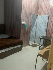 a bedroom with a bed and a table and a chair at Skyline hotel in Barnāla