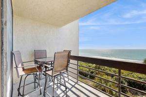 a balcony with a table and chairs and the ocean at Island Time Hideaway in Longboat Key