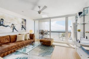 a living room with a couch and a large window at Island Time Hideaway in Longboat Key