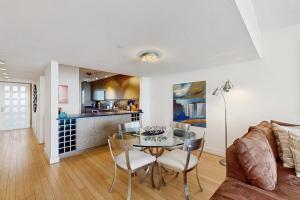 a dining room and kitchen with a glass table and chairs at Island Time Hideaway in Longboat Key