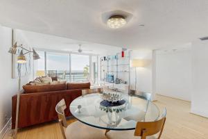 a living room with a glass table and a couch at Island Time Hideaway in Longboat Key +21 photos