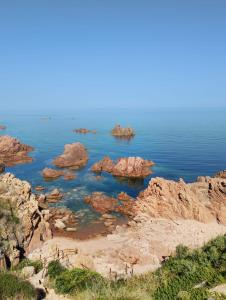 a view of the ocean with rocks in the water at Villa Paradiso holidays in Costa Paradiso