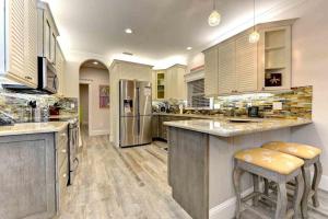 a large kitchen with wooden floors and a large island at Wine Down in Ilexhurst