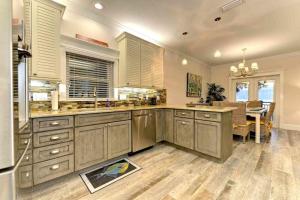 a large kitchen with wooden cabinets and a dining room at Wine Down in Ilexhurst