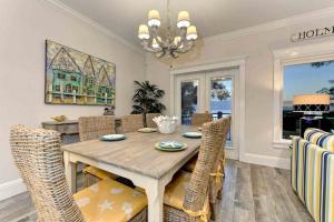 a dining room with a wooden table and chairs at Wine Down in Ilexhurst