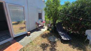 a house with a yard with a bench and a frisbee at CANj LOUNGE STUDIO in Čanj