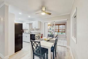 a kitchen and dining room with a table and chairs at Mint Green Getaway in Holmes Beach