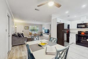 a kitchen and a living room with a table and chairs at Mint Green Getaway in Holmes Beach