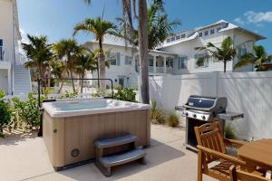 a hot tub and a grill on a patio at King Crab in Holmes Beach