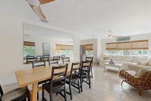 a dining room and living room with a table and chairs at King Crab in Holmes Beach +28 photos
