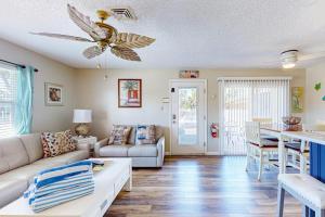 a living room with a couch and a ceiling fan at The Villas, Condo 1A in Holmes Beach