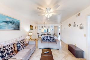 a living room with a couch and a ceiling fan at Shorewalk 103 in Bradenton