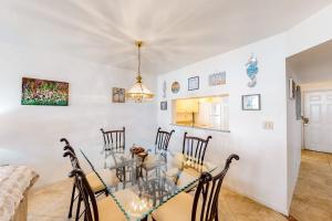 a kitchen and dining room with a table and chairs at Shorewalk 103 in Bradenton