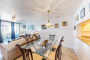 a dining room and living room with a table and chairs at Shorewalk 103 in Bradenton