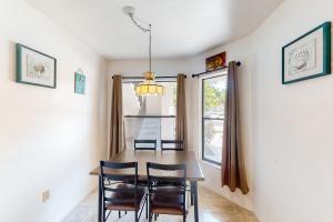 a dining room with a table and chairs and a window at Shorewalk 103 in Bradenton +16 photos