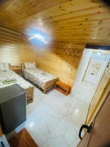 a room with two beds and a tv in it at Guest House Castle in Koman