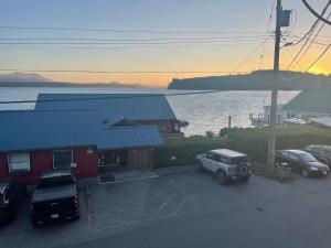 a car parked in a parking lot next to a building at Bayside Inn in Alert Bay