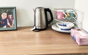 a coffee pot sitting on a counter next to a picture at The Fifth Season in Unanderra