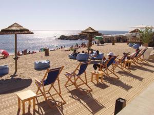 a beach with chairs and umbrellas and people on the beach at Studio Praia & Sol De Verão in Vila do Conde
